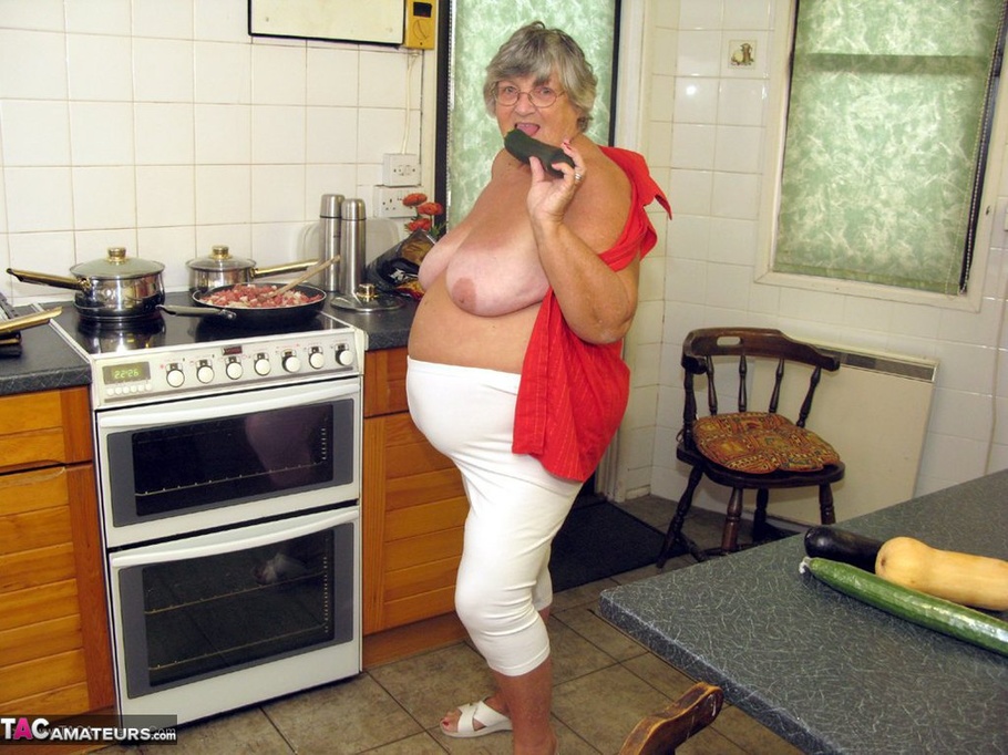 Big Fat Grandma Cooking Before She Takes Off Her Red Blouse And Squeeze A Huge Cucumber Between